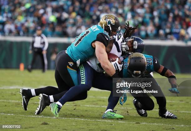 McKissic of the Seattle Seahawks is tackled by Paul Posluszny and Jalen Ramsey of the Jacksonville Jaguars in the second half of their game at...
