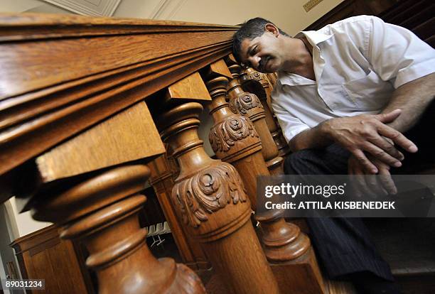 Un menuisier-sculpteur hongrois peaufine un siège doré pour le Saint-Père Master carpenter Arpad Rostas rests on his famous restored wood-stairs in...