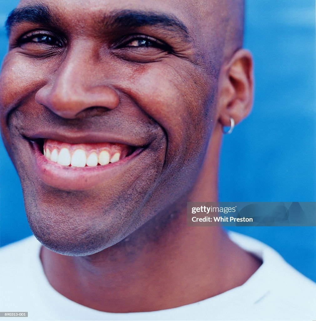 Young man smiling, close-up