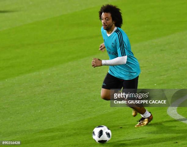 Real Madrid's Brasilian defender Marcelo dribbles the ball during a training session two days prior to his team's FIFA Club World Cup semi-final...