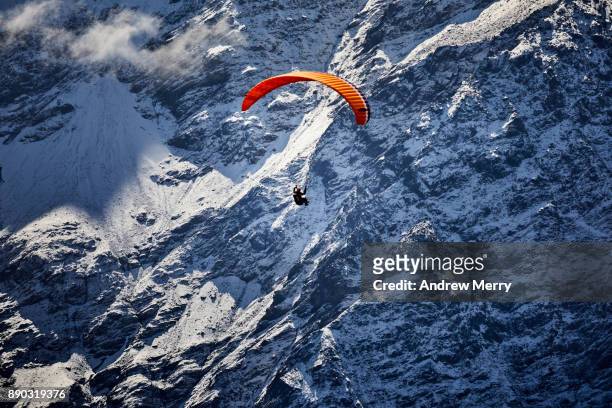 paragliding at high altitude in the chamonix valley with the steep mountain cliffs and clouds visible in the background. mont blanc mastiff, french alps - french mastiff stock pictures, royalty-free photos & images