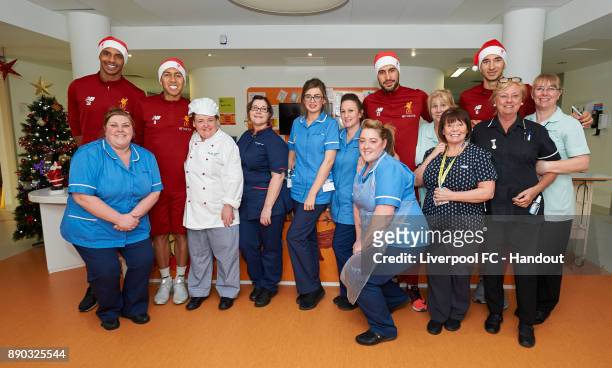 Liverpool players Joel Matip, Roberto Firmino, Emre Can and Marko Grujic pose with hospital staff while making their annual visit to Alder Hey...