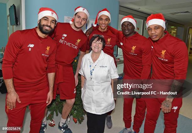 Mohamed Salah, Danny Ward, Trent Alexander-Ardold , Sadio Mane and Nathaniel Clyne of Liverpool with a member of staff at their annual visit at Alder...