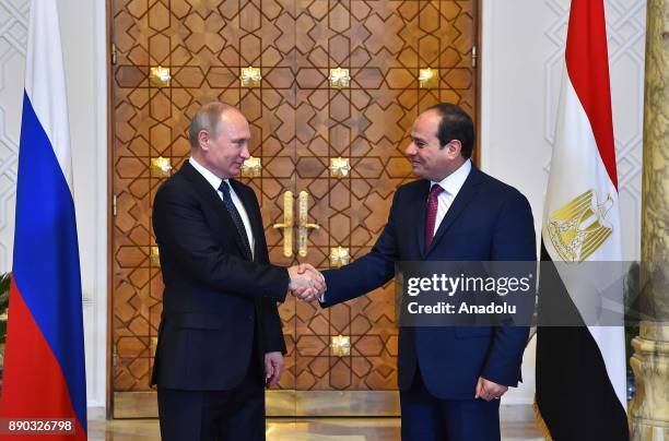 Russian President Vladimir Putin shakes hands with Egyptian President Abdel Fattah el-Sisi during their meeting on December 11, 2017 at Presidential...