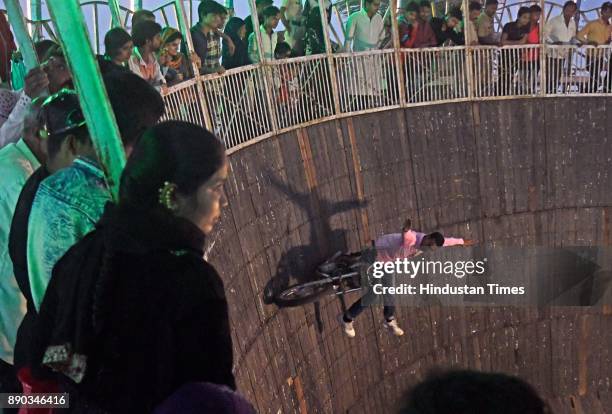 Stuntmen doing stunts in well of death at Mahim Fair on December 8, 2017 in Mumbai, India. Located at burial of Makhtoom Fakir Ali Paru , a famous...