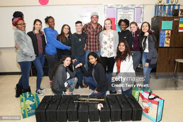 Country Music Artist Easton Corbin poses with Antioch High School Music Students after a surpise donation of music instruments by Cost Plus World...