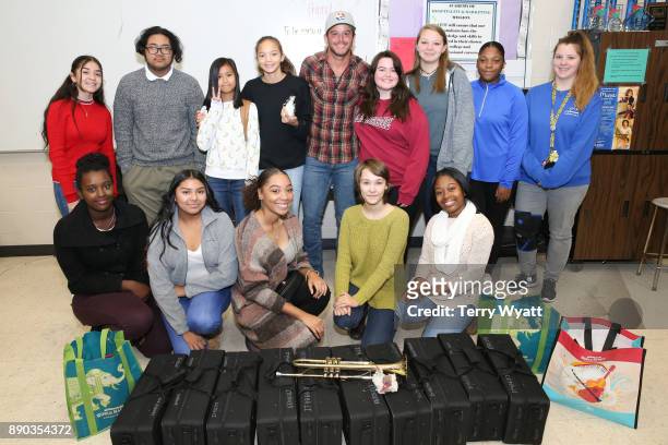 Country Music Artist Easton Corbin poses with Antioch High School Music Students after a surpise donation of music instruments by Cost Plus World...