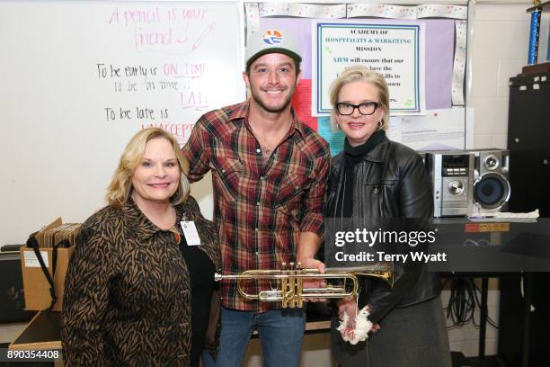 Dr. Nola Jones,Country Music Artist Easton Corbin and Pamela Virta during the Donation of Musical Instruments to Antioch High on December 11, 2017 in...