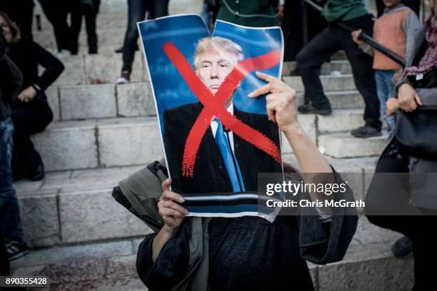 Protesters holds a poster of U.S. President Donald Trump in front of the Damascus Gate at the entrance to the Old City on December 11, 2017 in...