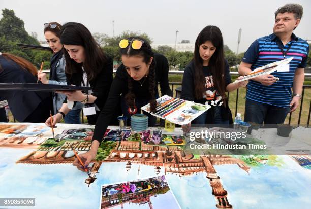 Artists painting Delhi tourist spots during 75 meter long live World Record Live Watercolor Painting at Central Park, Connaught Place on December 11,...