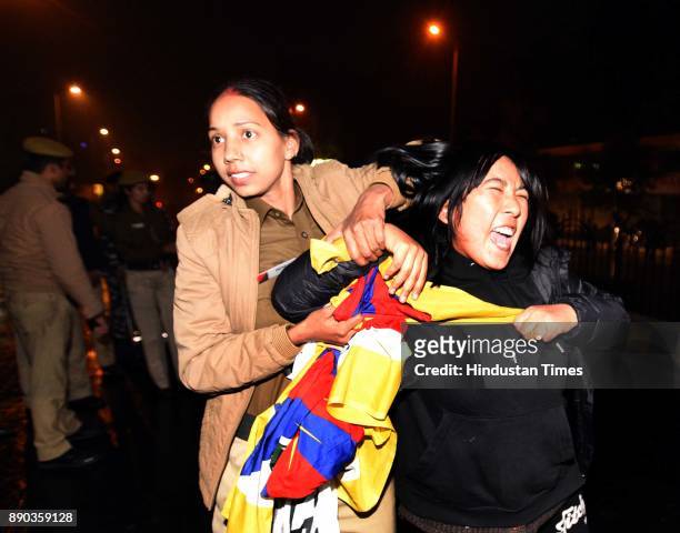 Delhi police detains an exile Tibetan protesting against China's occupation in Tibet, outside the hotel at Janpath Road where Chinese Foreign...