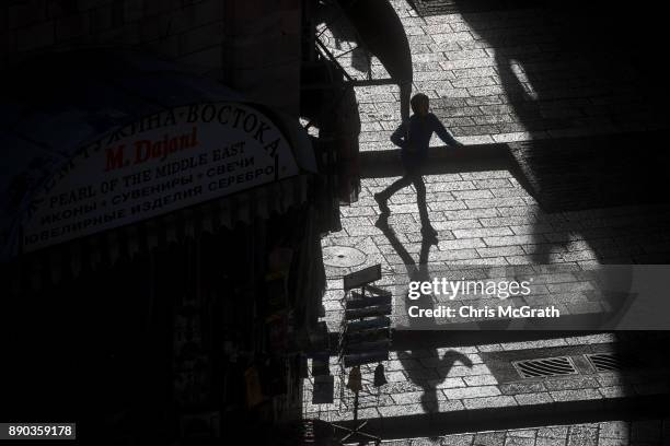 Boy walks through a street in the Old City on December 11, 2017 in Jerusalem, Israel. In an already divided city, U.S. President Donald Trump pushed...