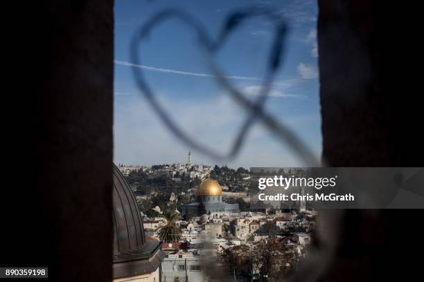 The Al-Aqsa Mosque is seen through a window covered with graffitti on December 11, 2017 in Jerusalem, Israel. In an already divided city, U.S....