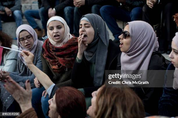 Protesters sing songs and chant slogans in front of the Damascus Gate at the entrance to the Old City on December 11, 2017 in Jerusalem, Israel. In...