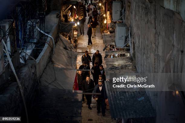 Jewish men walk on a street in the Old City on December 11, 2017 in Jerusalem, Israel. In an already divided city, U.S. President Donald Trump pushed...