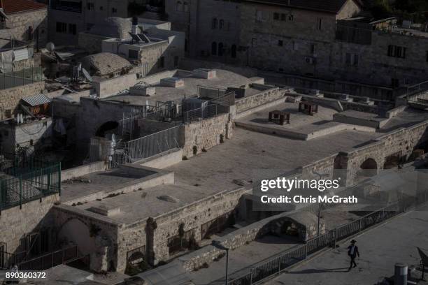 Jewish man walks across rooftops in the Old City on December 11, 2017 in Jerusalem, Israel. In an already divided city, U.S. President Donald Trump...