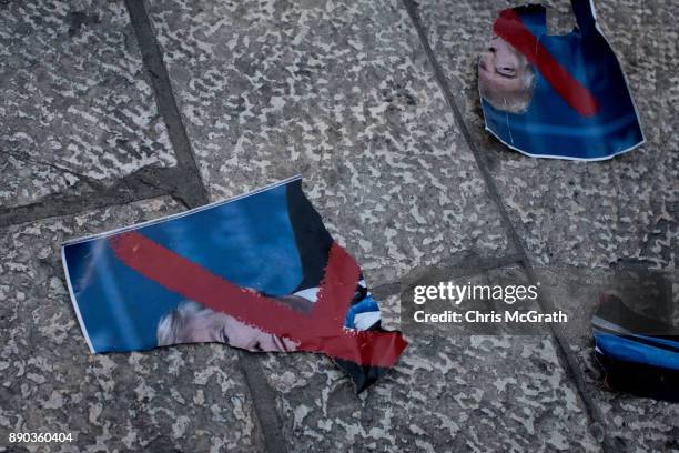 Ripped pieces of a poster of U.S. President Donald Trump is seen on the ground during a protest in front of the Damascus Gate at the entrance to the...