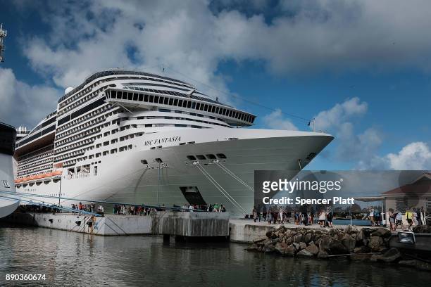Tourists arrive from a cruise ship in St. John's on December 11, 2017 in St John's, Antigua. While its sister island of Barbuda was nearly destroyed...