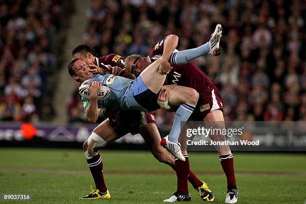Kurt Gidley of the Blues is tackled during game three of the ARL State of Origin series between the Queensland Maroons and the New South Wales Blues...