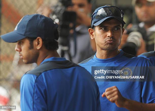 Indian cricketers Manoj Tiwari and S. Badrinath look on during a practice match at the National Cricket Academy in Bangalore on July 15 2009. A five...