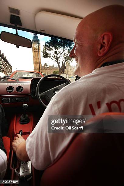 Protester Bob Hills drives in a convoy of Vauxhall cars around Parliament Square in Westminster in a campaign to safeguard workers' jobs on July 15,...