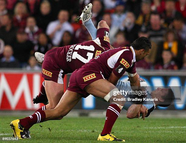 Kurt Gidley of the Blues is tackled during game three of the ARL State of Origin series between the Queensland Maroons and the New South Wales Blues...