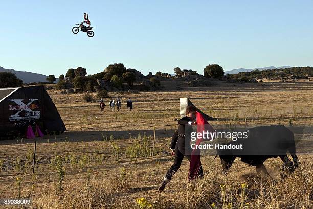In this handout photo provided by Redbull, Spanish rider Dany Torres performs a show jump over a traditional torero on July 14, 2009 at the Pajar...