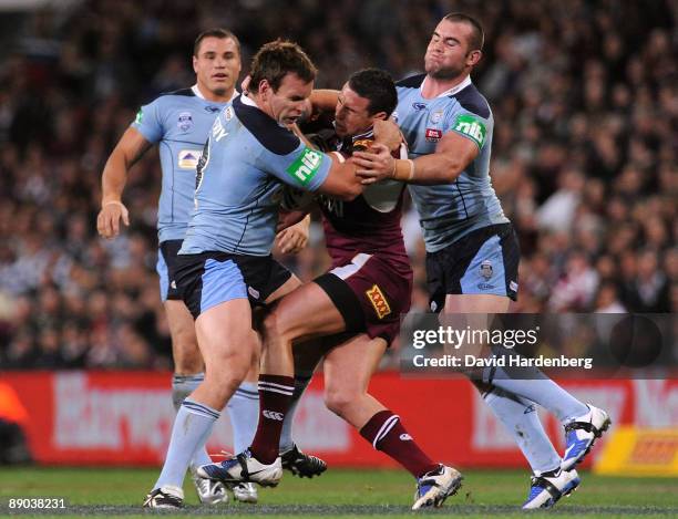 Darius Boyd of the Maroons gets tackled by the Blues defence during game three of the ARL State of Origin series between the Queensland Maroons and...