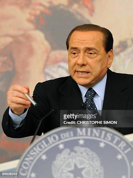 Italian Prime Minister Silvio Berlusconi gives a press conference following a ministers' council on July 15 at Palazzo Chigi in Rome. Italian...