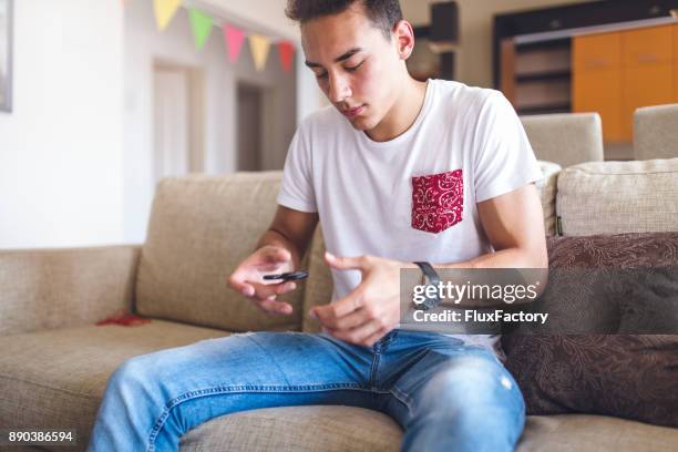 young man with spinner - fidget spinner stock pictures, royalty-free photos & images