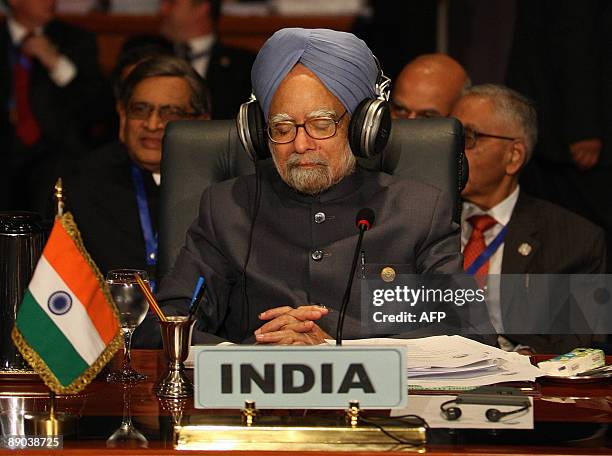 India's Prime Minister Manmohan Singh occupies his seat moments before the inauguration ceremony of the 15th summit of the Non-Aligned Movement in...