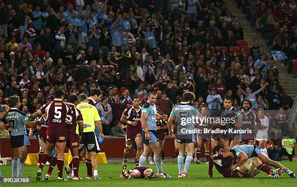 Brawl erupts as Steve Price is seen on the ground unconcious during game three of the ARL State of Origin series between the Queensland Maroons and...