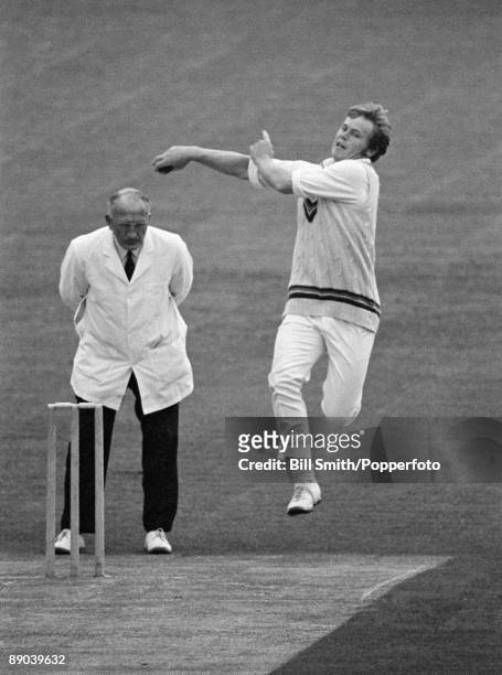 Mike Procter bowling for Gloucestershire against Northamptonshire at the County Ground in Northampton, 21st June 1971. The umpire is Tom Spencer.