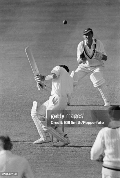 Derbyshire batsman DHK Smith ducks a bouncer from Yorkshire's Richard Hutton at Derby, circa 1969. The Yorkshire wicketkeeper is Jimmy Binks.