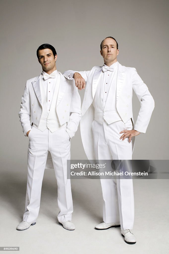 Two men in white tuxedos standing