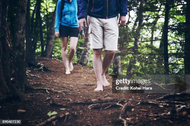 couple hiking barefoot in the mountain - barefoot stock pictures, royalty-free photos & images