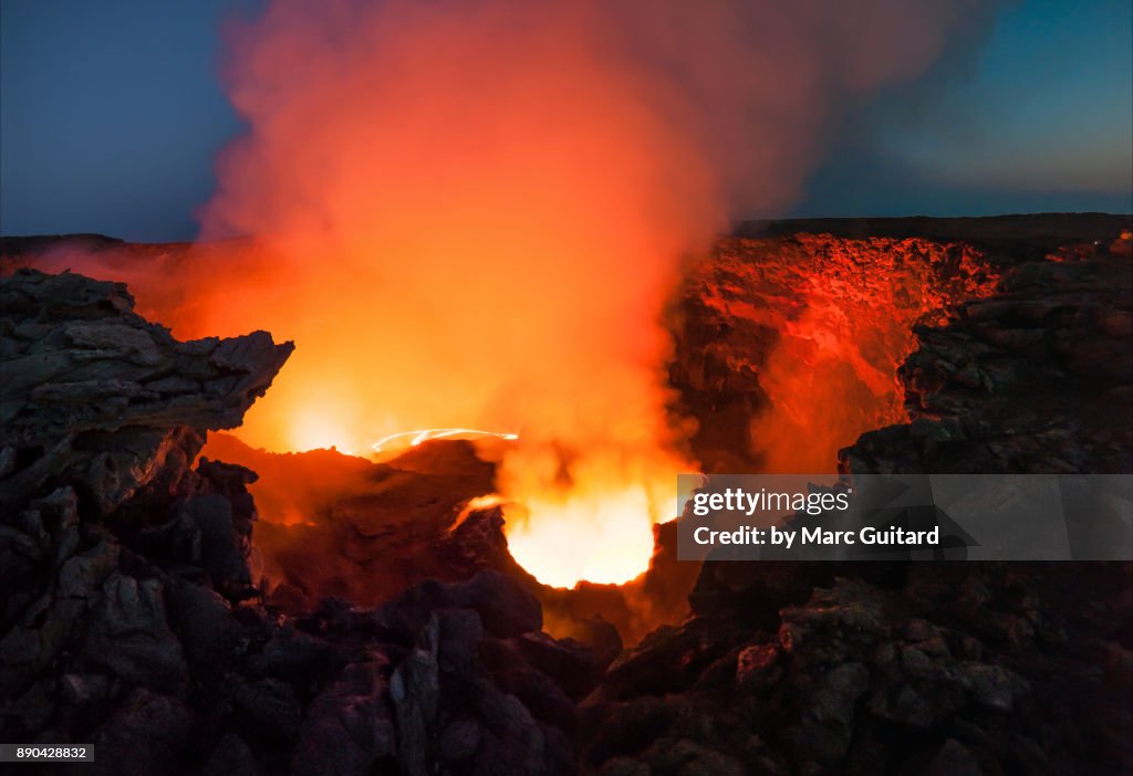Lava and smoke thrash inside the crater of Erta Ale, an extremely active shield volcano located in the Danakil Depression in the Afar Region of Ethiopia