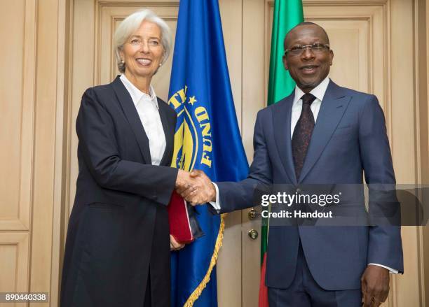 In this handout image provided by the International Monetary Fund, International Monetary Fund Managing Director Christine Lagarde is greeted by...