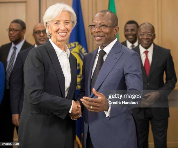 In this handout image provided by the International Monetary Fund, International Monetary Fund Managing Director Christine Lagarde is greeted by...
