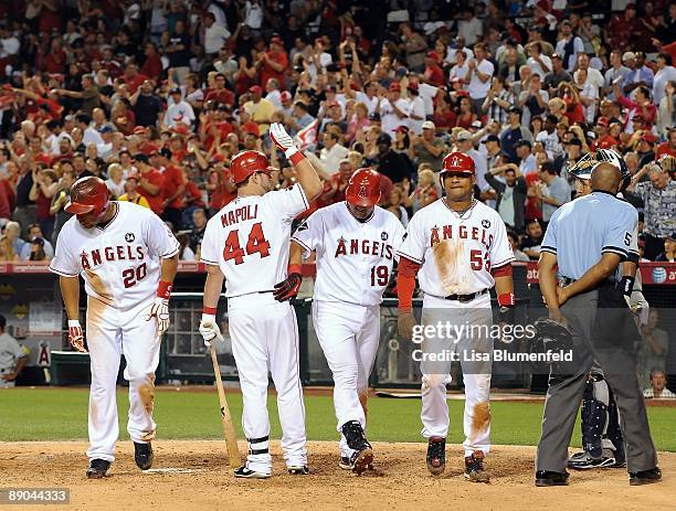 Maike Napoli of the Los Angeles Angels of Anaheim congratulated teammate Kendry Morales after hitting a three run homerun in the fifth inning against...