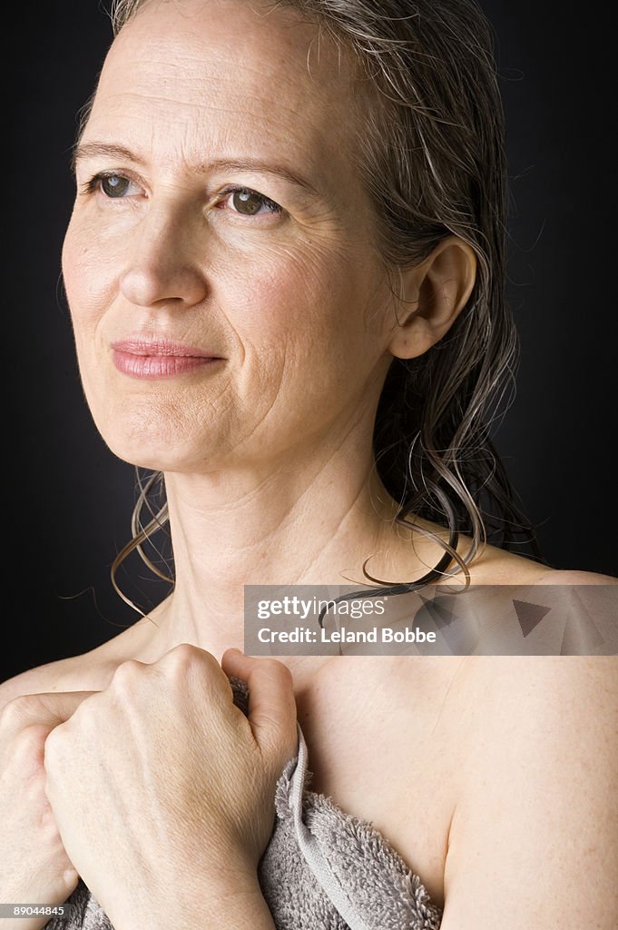 Portrait of happy mid-aged woman with wet hair ver