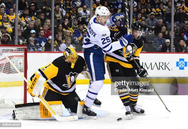 James van Riemsdyk of the Toronto Maple Leafs is pushed by Brian Dumoulin of the Pittsburgh Penguins at PPG PAINTS Arena on December 9, 2017 in...