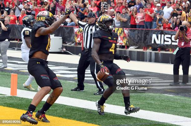 Darnell Savage Jr. #4 of the Maryland Terrapins returns an interception for a touchdown against the Towson Tigers on September 9, 2017 in College...