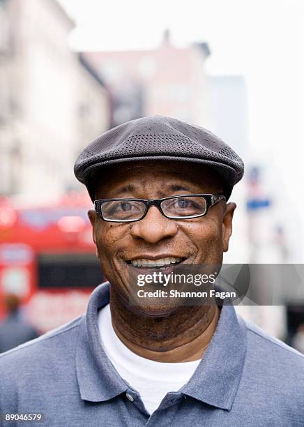 portrait of older gentleman on busy city street - flat cap 個照片及圖片檔