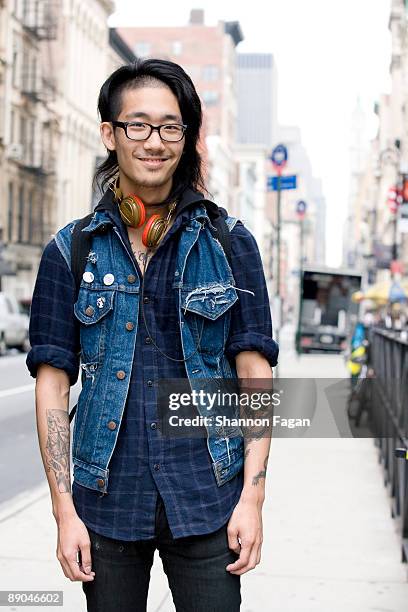 young hipster boy standing on city street - korean man stockfoto's en -beelden