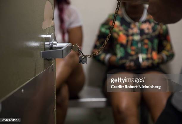 An officer with the Los Angeles Police Department's vice squad, right, speaks with some of the 13 women arrested earlier in the day in a holding cell...