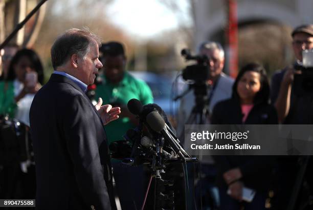 Democratic Senatorial candidate Doug Jones speaks to reporters following a campaign stop at Martha's Place on December 11, 2017 in Montgomery,...