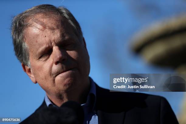 Democratic Senatorial candidate Doug Jones speaks to reporters following a campaign stop at Martha's Place on December 11, 2017 in Montgomery,...