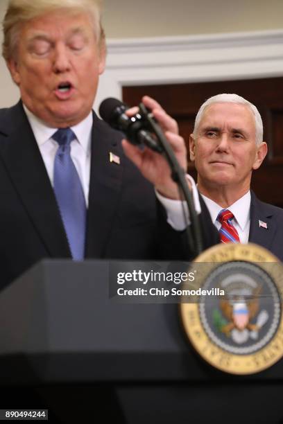 Vice President Mike Pence listens to President Donald Trump deliver remarks before signing 'Space Policy Directive 1' in the Roosevelt Room at the...