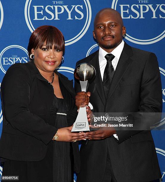 Nelson Mandela's daughter Zindzi Mandela and Nelson Mandela's grandson Zondwa Mandela pose with the Arthur Ashe Courage Award which they accepted on...